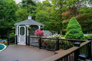 Exterior deck with a pool and gazebo