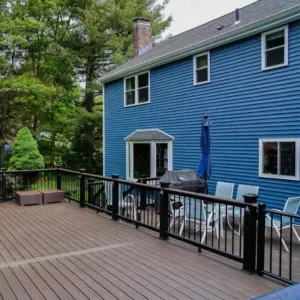 Modern backyard deck and blue siding renovation by MT Remodel, specialists in home remodeling in Connecticut.
