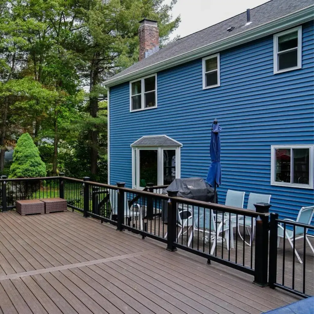 Modern backyard deck and blue siding renovation by MT Remodel, specialists in home remodeling in Connecticut.