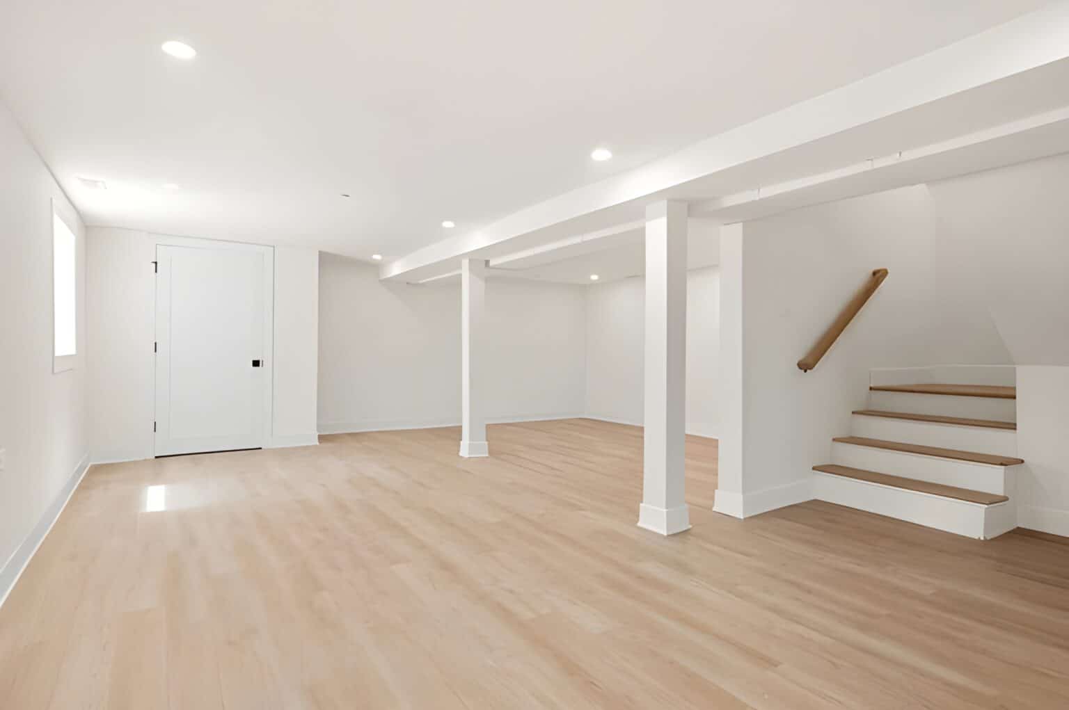 Empty, bright basement with stairs