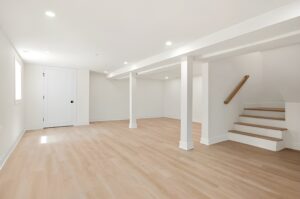 Empty, bright basement with stairs