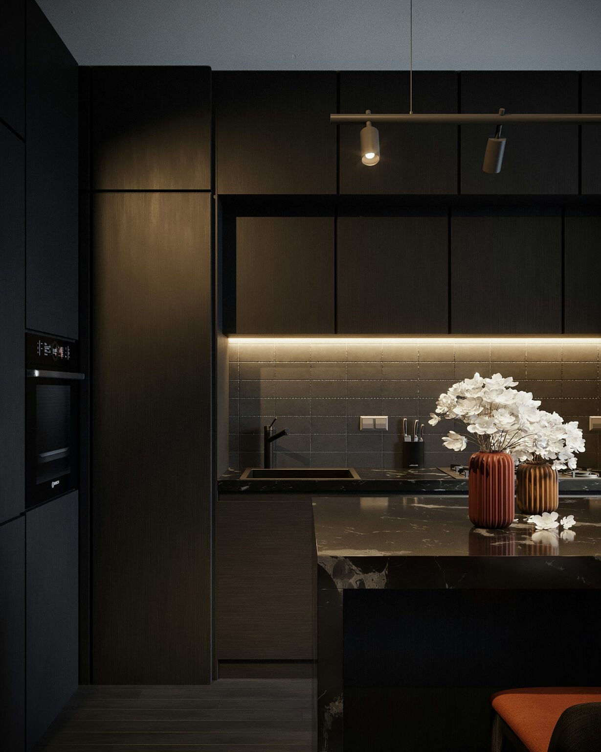 Moody black kitchen with black marble countertops