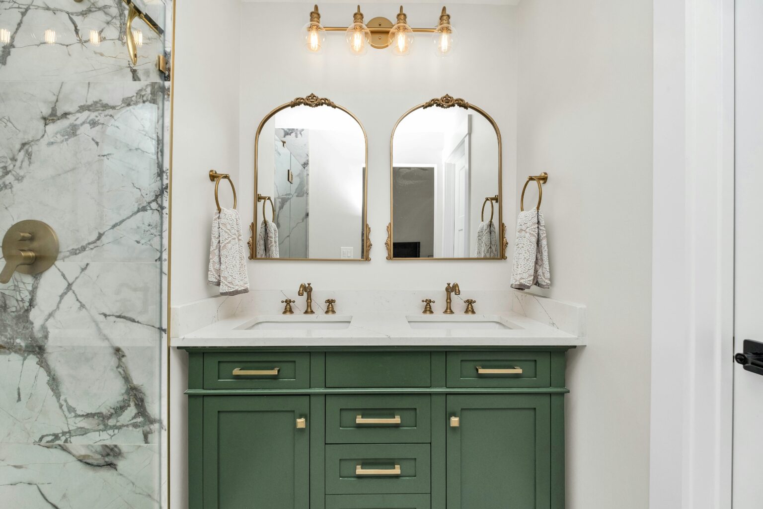Bathroom with gold accents and green vanity. home remodeling contractor in Groton.